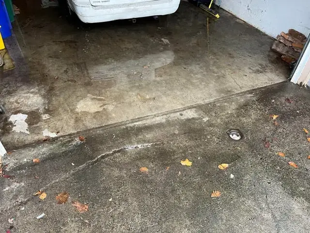 Wet concrete garage floor after the standing water was pushed out in Pico Rivera, CA