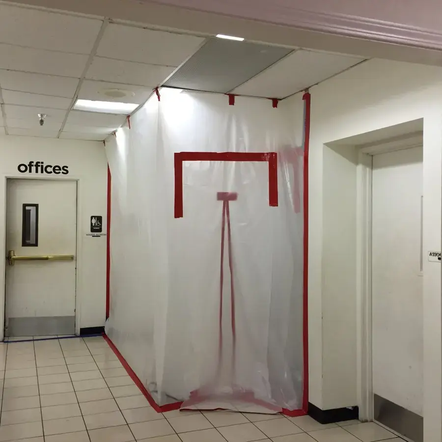Office corridor sealed with plastic containment for drying in Pico Rivera, CA